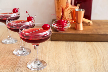 Glasses of tasty Manhattan cocktail on wooden table, closeup