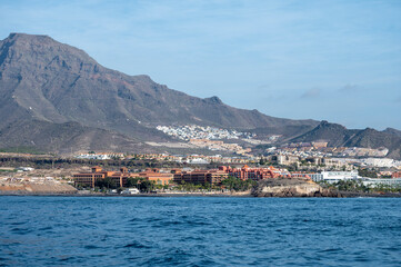 Fototapeta premium View on resorts and beaches of South coast of Tenerife island during sail boat trip along coastline, Canary islands, Spain