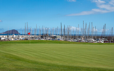 Green lawn grass on year-round outdoor golf course located nead yacht harbor on Tenerife, Canary islands, Spain