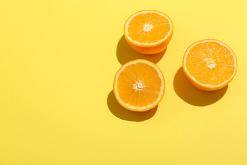 Fresh cut oranges on yellow background