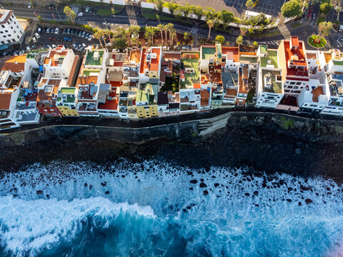 Aerial view on colorful houses and black lava rocks in small village Punta Brava near Puerto de la Cruz, Tenerife, Canary islands at sunrise