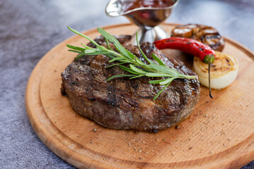 ribeye steak a piece of veal and beef grilled on a wooden board in a restaurant