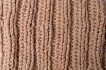 Knitted woolen sweater as background, closeup