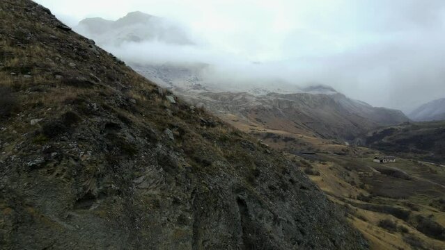 Chegem Gorge in fog Caucasian mountains in snowfall drone shooting nature landscapes cloudy weather