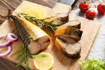 Board with cut smoked mackerel fish on table