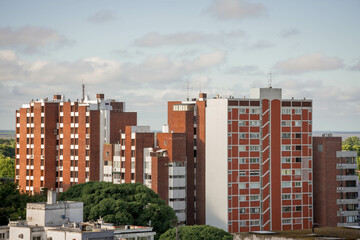 San Isidro city buildings, red brick towers, in wooded area