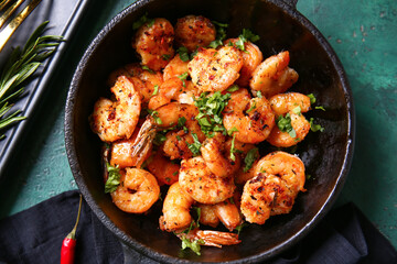 Frying pan of tasty shrimp tails on table