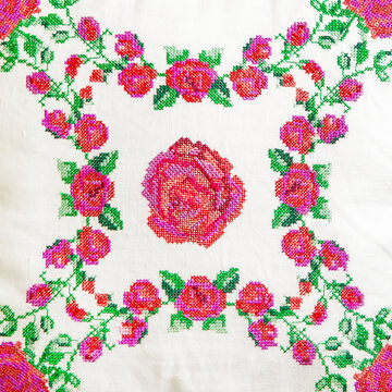 Decorative element, cross-stitch embroidery of rose flowers.