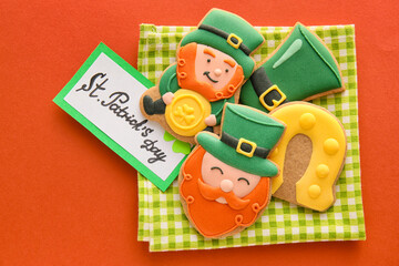 Composition with tasty gingerbread cookies for St. Patrick's Day celebration on color background