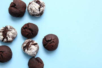 Tasty chocolate brownie cookies on blue background