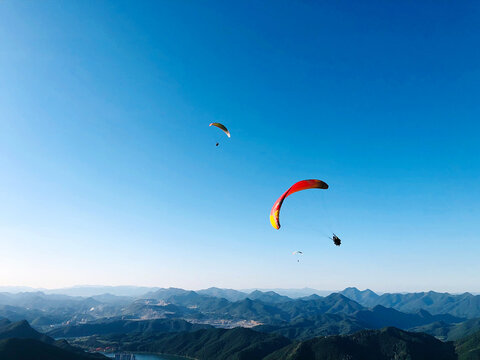 Kite Flying Over Mountain Against Blue Sky
