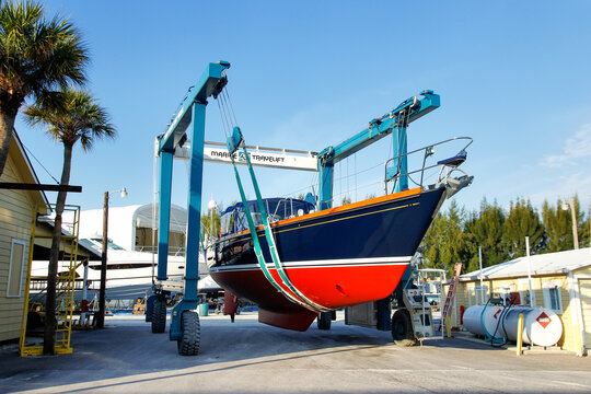 FLORIDA, USA - MARCH 11: Sailboat in a sling at marina warehouse on March 11, 2014 in Florida, USA. Sailing is a very popular activity on the Florida coast