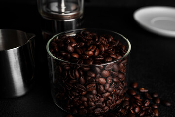 Coffee beans on a dark background. Coffee beans in cup.