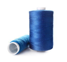 Blue sewing thread spools on white background