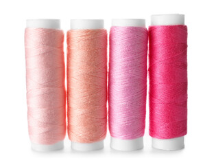 Multicolored sewing thread spools on white background
