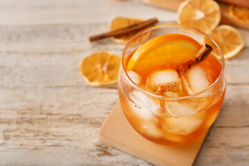 Glass of tasty Old Fashioned Cocktail on white wooden background