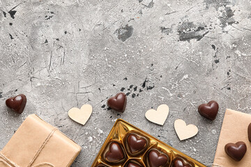 Box with tasty heart-shaped candies on grey background