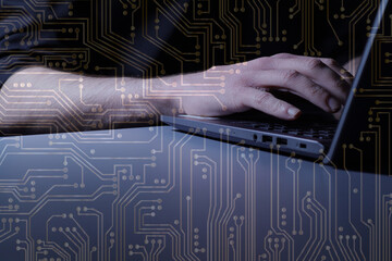 Hands at laptop with motherboard circuit overlay graphic