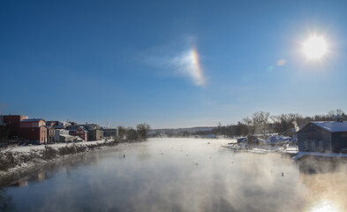 Icy rive with smog in the morning  in the Canadian cold winter in the province of Quebec