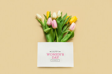 Bouquet of beautiful tulip flowers and card for International Women's Day on color background