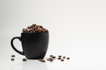 Coffee beans in black cup, close-up