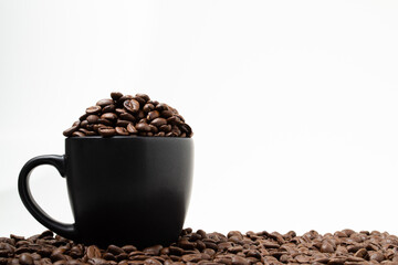 Coffee beans in black cup, close-up