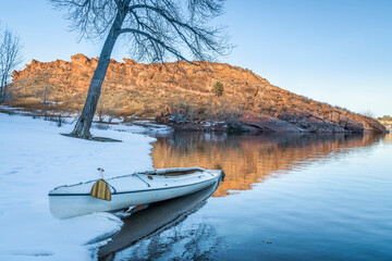 decked expedition canoe in winter scenery of Horsetooth Reservoir in northern Colorado