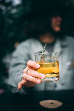 White negroni cocktail outside, in the teal color natural background