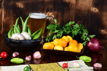 pequi fruit typical Brazilian food, okra spices, salad and melted cheese au gratin with choop mug on blurred background