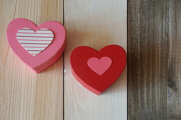 Pink Decorated Heart Box and Red Decorated Heart Box on Variegated Wood Paneling