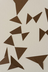 pointy paper shapes (triangles) on beige paper