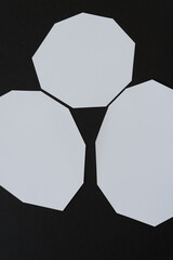 white polygonal shaped paper arranged in an abstract composition