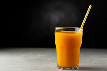 Mango juice in glass cup on the table. Mango smoothie.