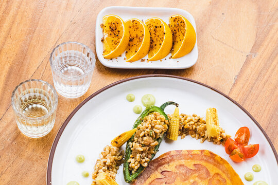 Chile relleno de escamoles y mezcal con naranjas