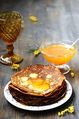 corn pancakes with jam on a dark background , apricot or peach jam, pancake holiday 