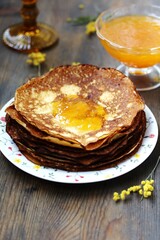 corn pancakes with jam on a dark background , apricot or peach jam, pancake holiday 