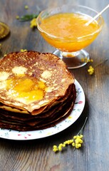 corn pancakes with jam on a dark background , apricot or peach jam, pancake holiday 