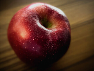 Red apple close-up on brown teak wood table