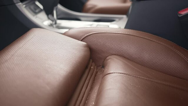 Close up view of dirty driver's leather seat at the car. Carwash or Car Detailing process