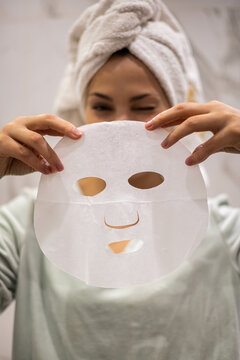 Portrait Happy Young Domestic Woman Posing Holding Hydration Cooling Tissue Face Mask For Skin Care