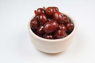 Chinese red date or Jujube asian herbal fruit for healthy on white background under sunlight. The fruit and its seeds are used in Chinese traditional medicine.