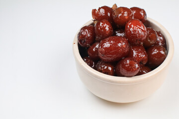 Chinese red date or Jujube asian herbal fruit for healthy on white background under sunlight. The fruit and its seeds are used in Chinese traditional medicine.