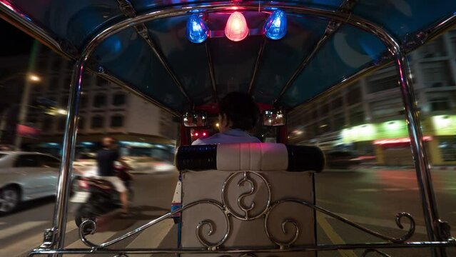 Timelapse of driving tuktuk in night Bangkok, Thailand