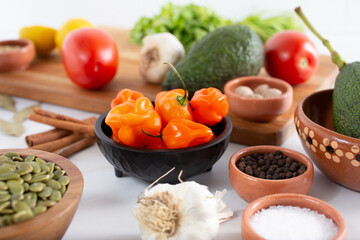A view of a salsa dish full of habanero chili peppers.