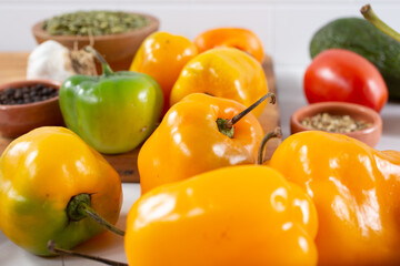 A closeup view of several manzano chili peppers.