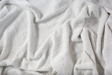 Fototapeta premium A top down view of a wrinkled towel background.