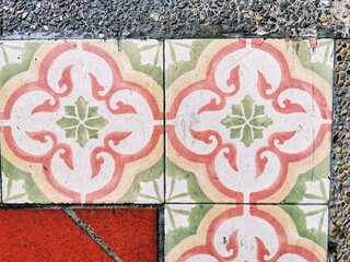 Beautifully decorated tiles on a floor.