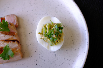 Marinated porks with Fish sauce and betel nut mix spicy sauce on the Egg

