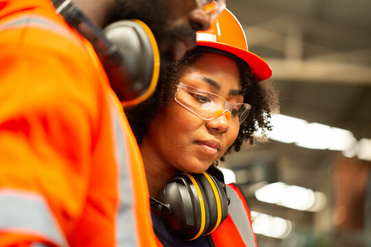 Close up African engineer on site working with her team