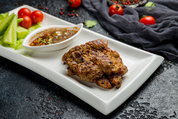 roast pork with hot sauce on dark stone table, Chinese Cuisine